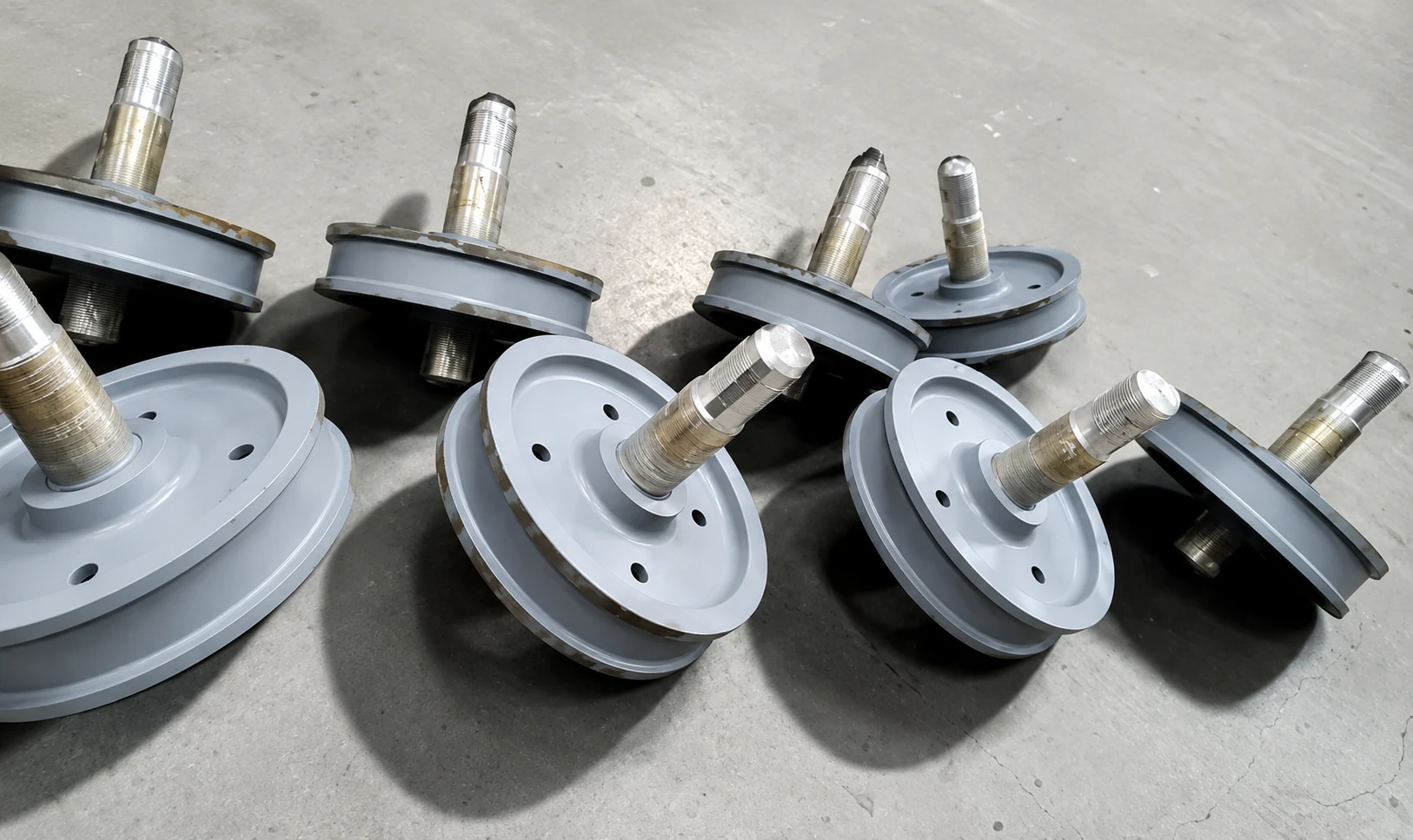 Batch of painted crane wheels with protected shafts
