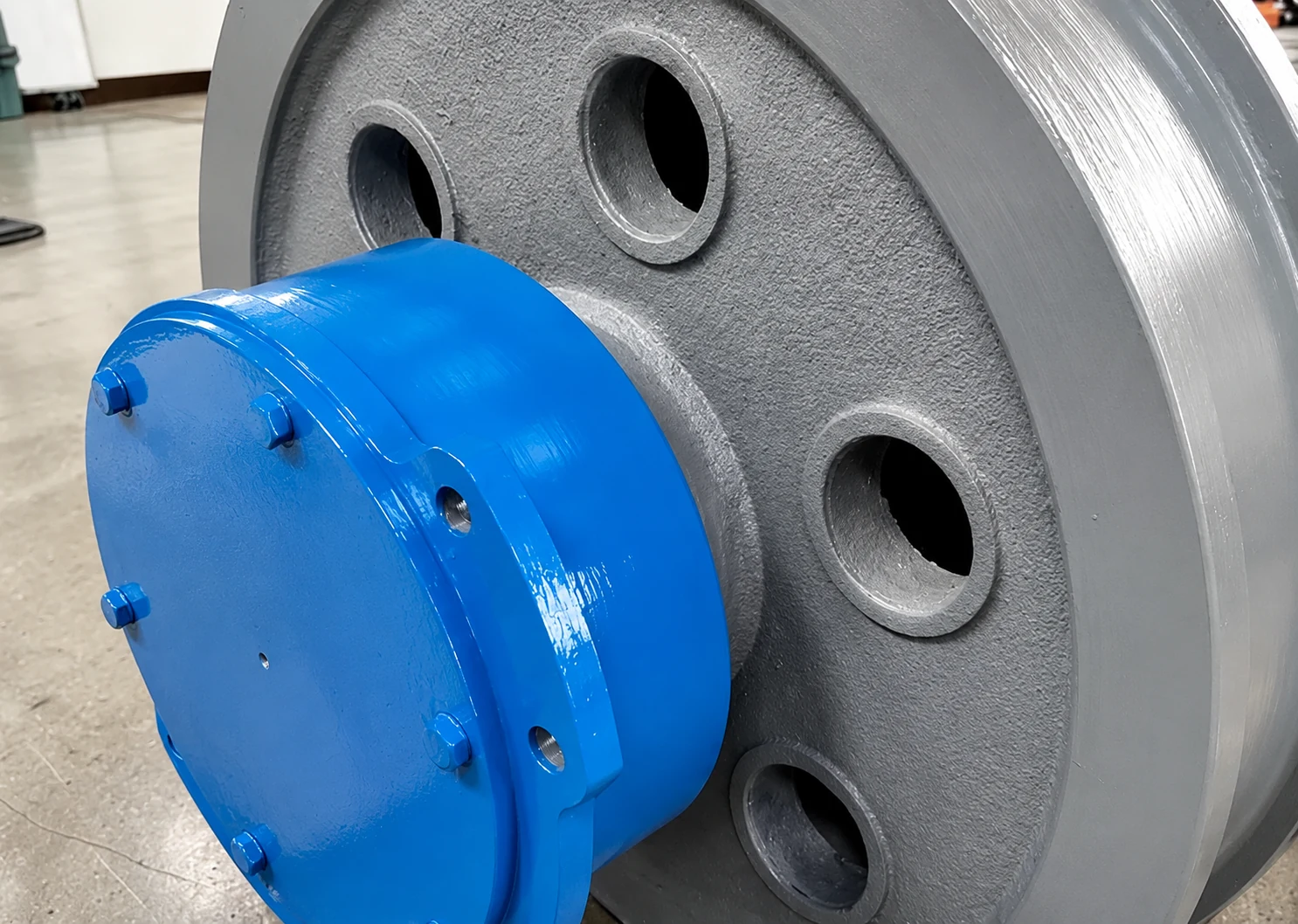 Crane wheel assembly with blue bearing housing and machined steel wheel