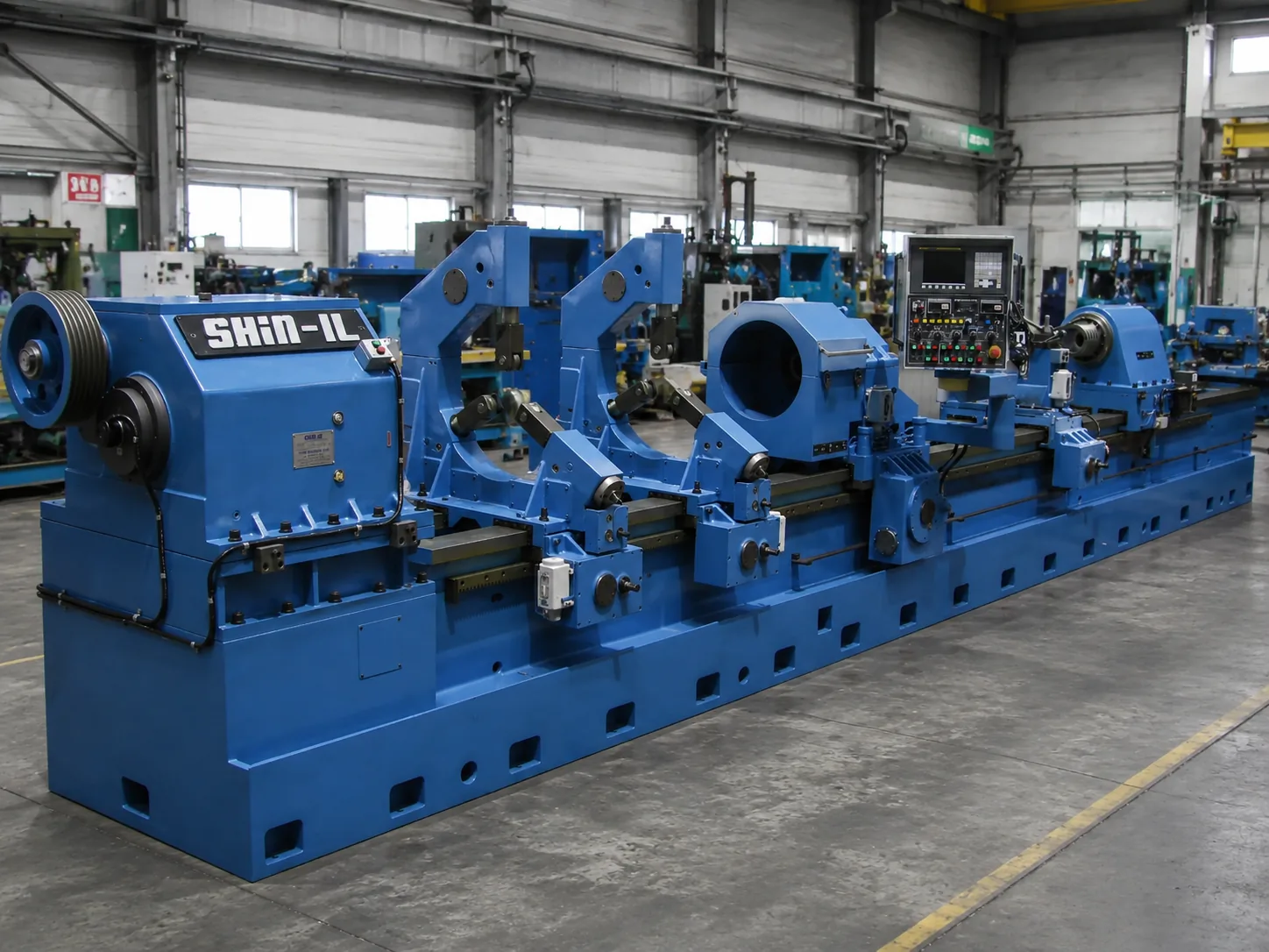 Large blue SHIN-IL deep hole drilling machine in an industrial workshop