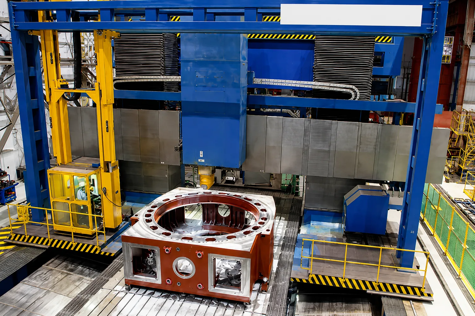 Large CNC milling machine processing a heavy industrial housing