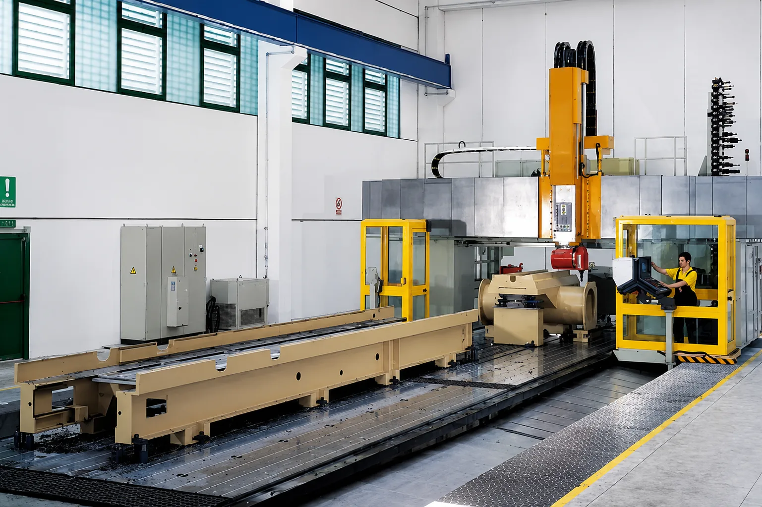 Long-bed CNC milling machine with yellow operator cabin and large workpiece
