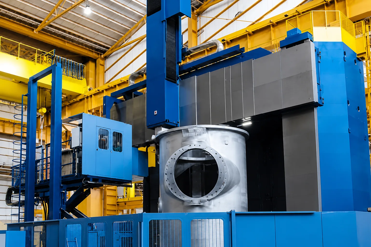 Large machined cylindrical component positioned on a blue vertical turning machine