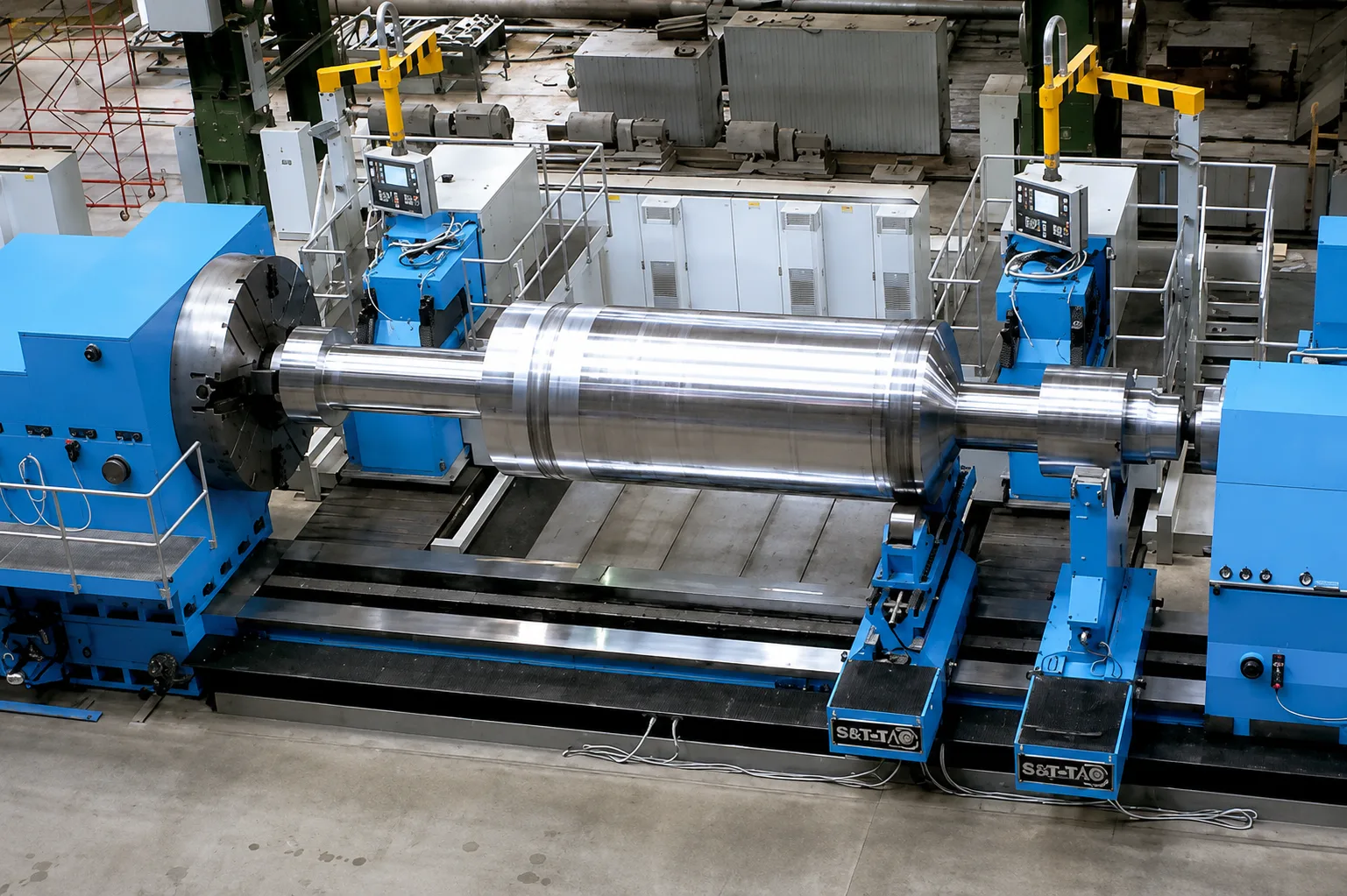Long polished shaft held between blue turning machine supports