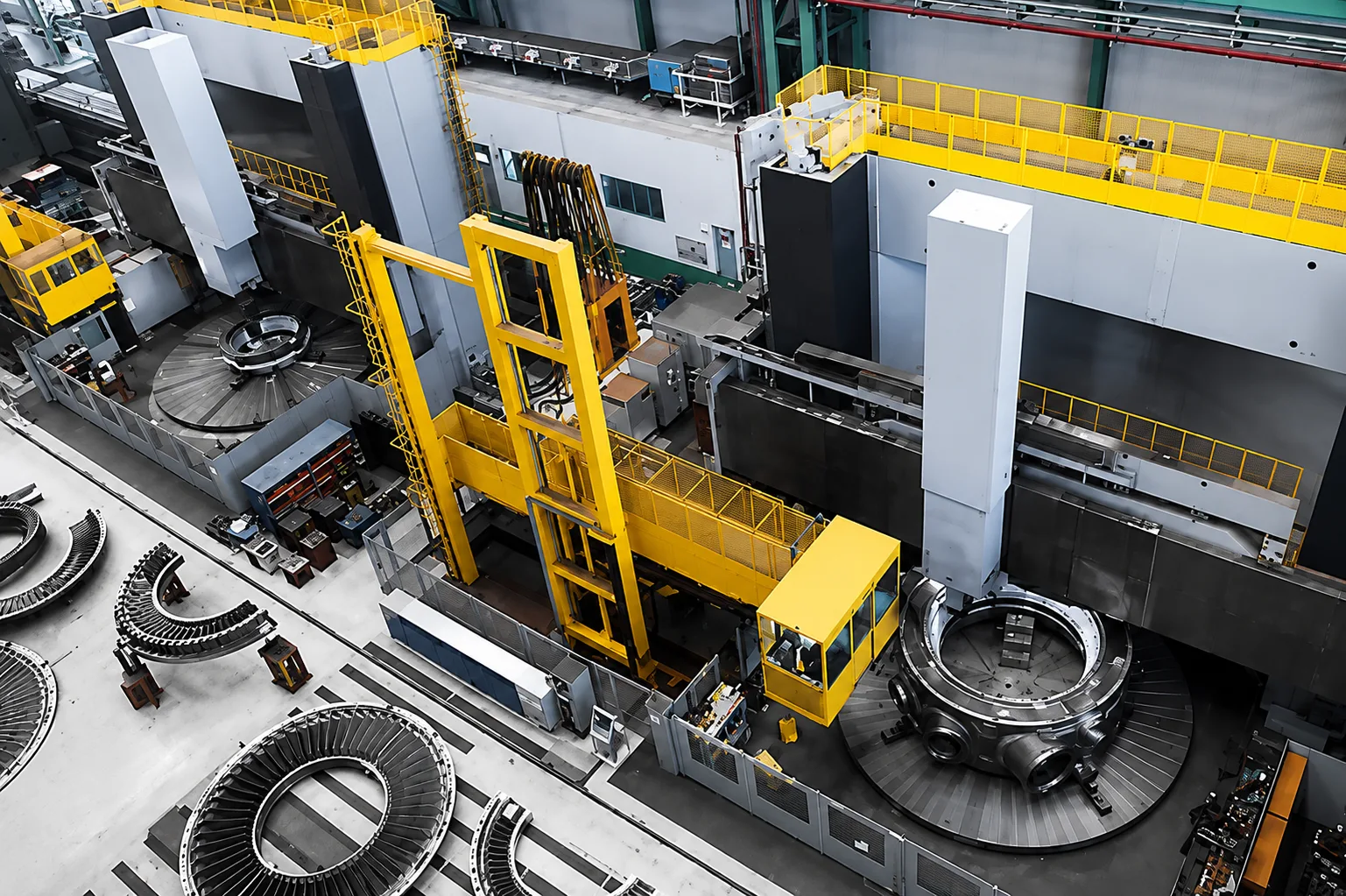 Aerial view of large vertical turning machines and heavy circular components in the machining workshop