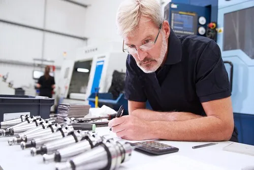 Industrial specialist inspecting precision components in a workshop