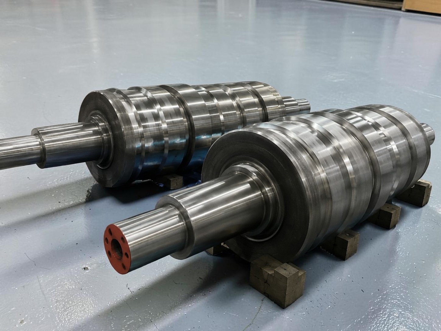 Two new profiled rolling mill rolls with precision-machined grooves and journals