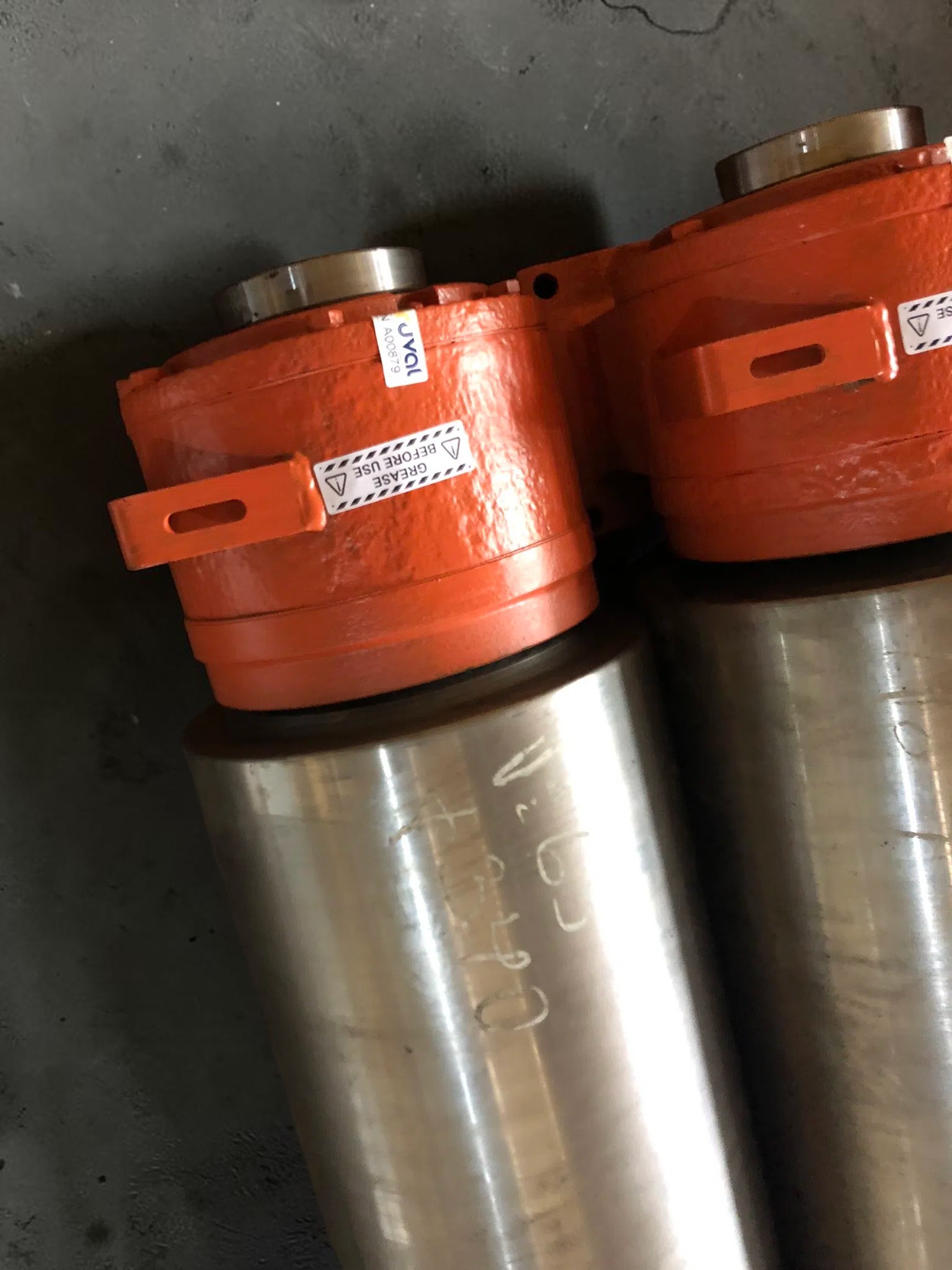 Close view of painted bearing housings on finished rolling mill rolls