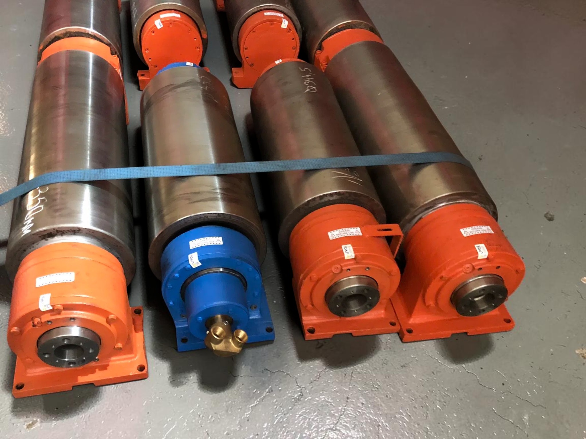 Finished rolling mill roll assemblies with painted bearing housings prepared for handling